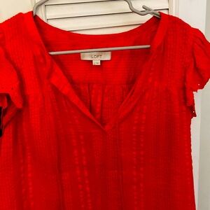 Orange flutter sleeve top eyelet.